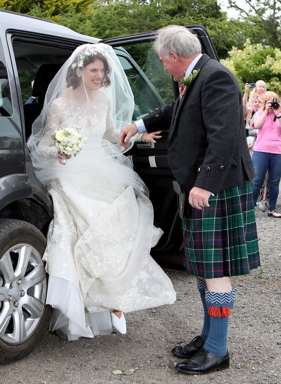 The bride is stepping out of the car, with her Dad, Sebastian ready to give her his arm, one final time. So Christian and proper! 